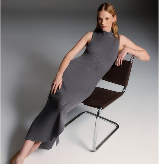 Model is wearing grey crewneck maxi dress.